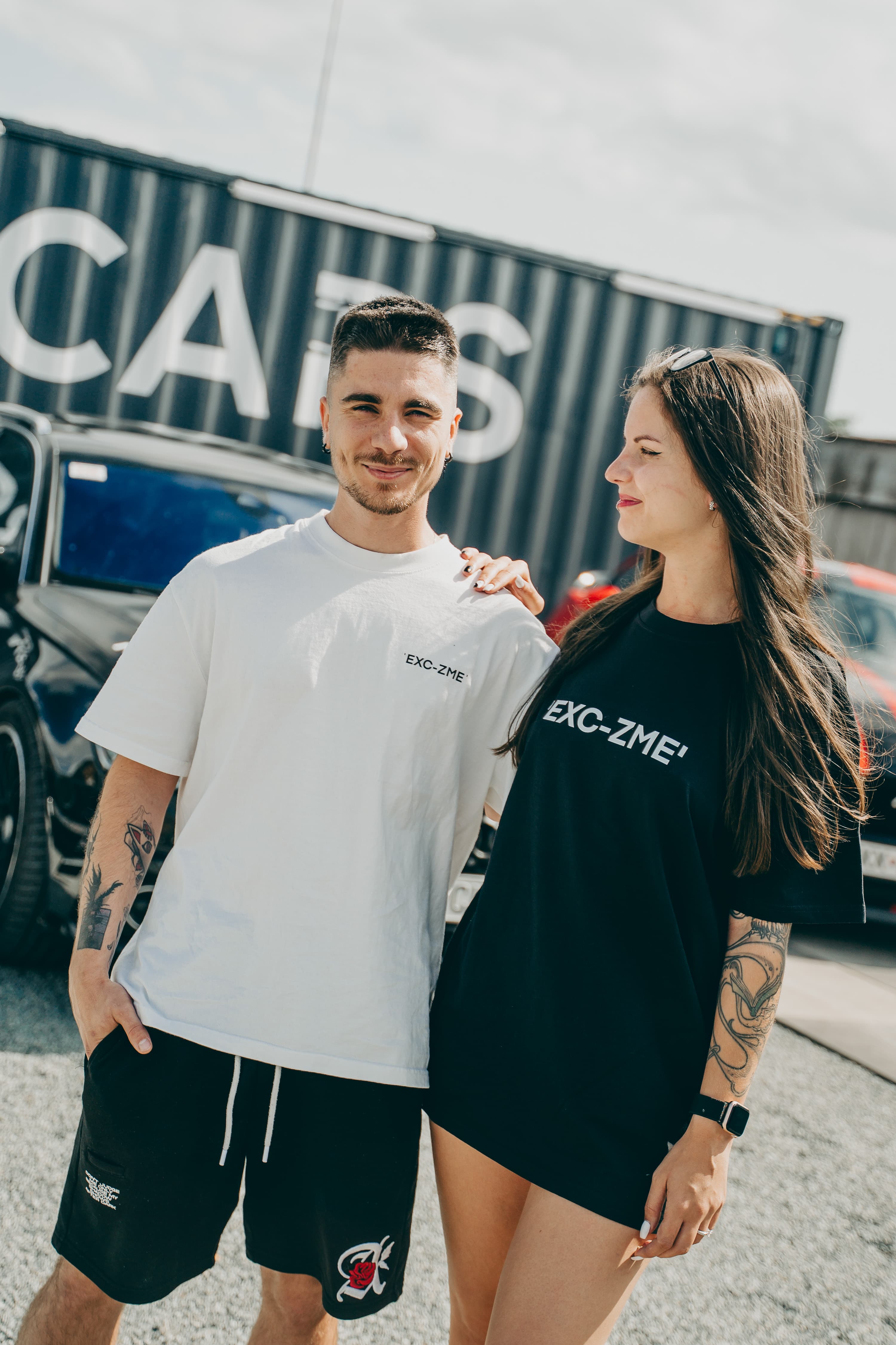 Black tee line styled in a portrait shot from the same session.